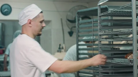 The baker gets just baked bread Video stock 92579070