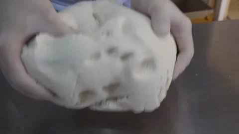 Baker in Gloves Kneading Raw Dough on Stainless Steel Countertop Stock Footage 345291736