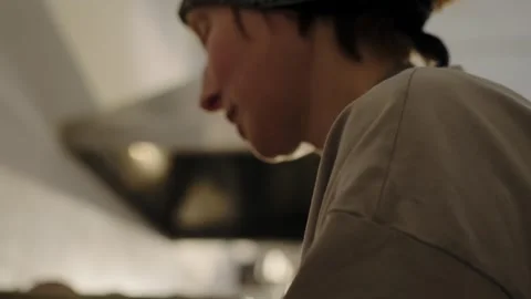 A baker grinds nuts with a blender for almond croissants and smiling. Stock Footage 267016516