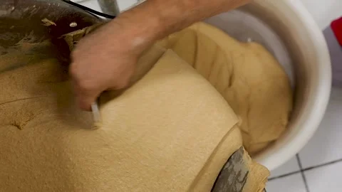 Baker Guiding Dough Into Proofing Bucket Stock Footage 340933582