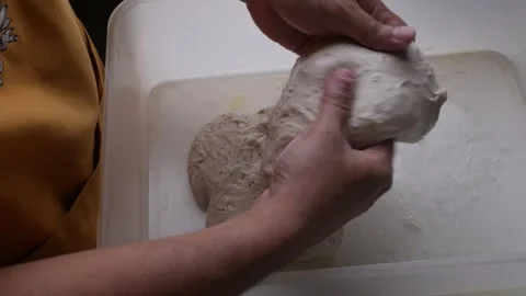 Baker hand doing coil foldto make sourdough bread. Stock Footage 306638289