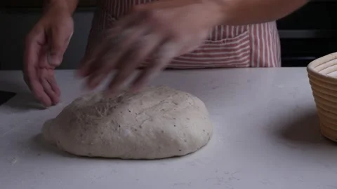 Baker hand put raw dough to proofing banneton basket. Stock Footage 306158557