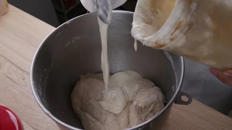 Baker hand put starter yeast to make sourdough bread. Stock Footage 305981305