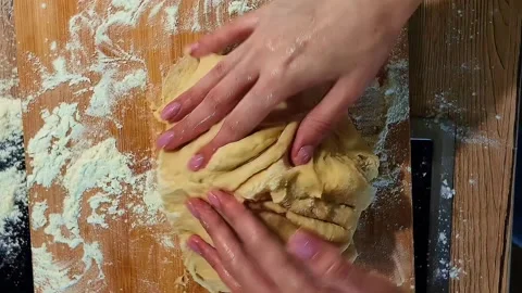 Baker hand stirring yellow mass with flour ingredient in stainless steel bowl 스톡 동영상 337257102