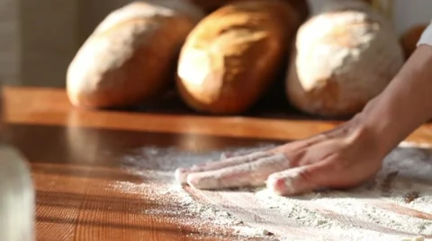 Baker hand throwing flour on the table, slow motion, dolly shot HD Stock Footage 10725792