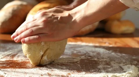 Baker hand throwing flour on the table and kneading dough, slow motion Stock Footage