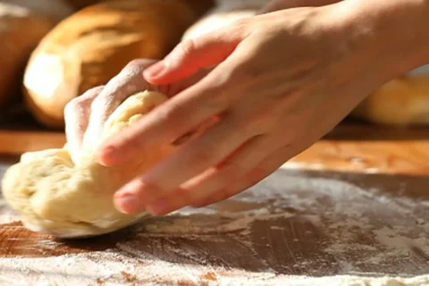 Baker hand throwing flour on the table and kneading dough, slow motion Stock Footage 10735123