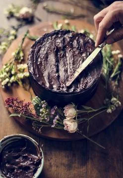 Baker Hand Using Spatula with Chocolate Cake Stock Photos