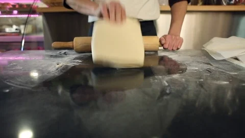 Baker hands cutting dough in flour on table Stock Footage 75074452