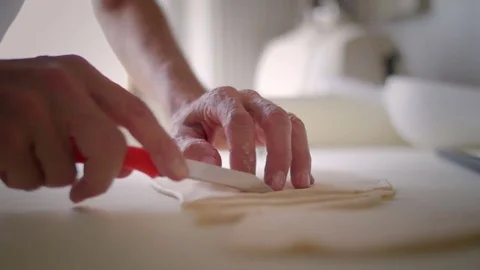 Baker hands cutting the dough Stock Footage 76558455