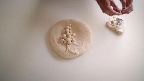 Baker hands decorating bread with ecclesiatical symbol Stock Footage 76559672