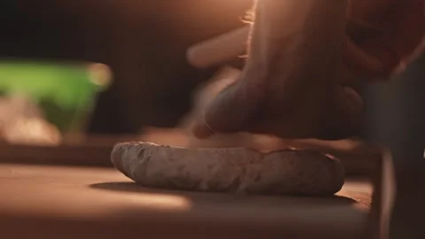 Baker hands kneading dough for bread preparation on wooden table. Food artisan Vidéo 344862352