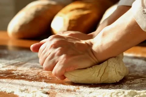 Baker hands kneading dough in flour on table, slow motion Stock Footage 10735149