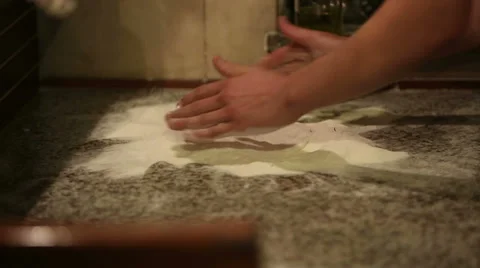 Baker hands kneading dough in flour on table Stock Footage 39786256