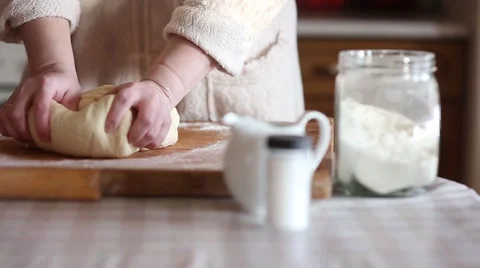 Baker hands kneading dough in flour on table, slow motion Stock Footage 61581502
