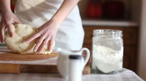 Baker hands kneading dough in flour on table, slow motion Stock Footage 61581677