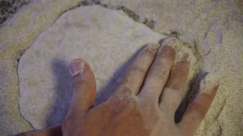 Baker hands kneading dough in flour on table Stock Footage 67479899