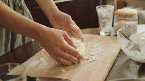 Baker hands kneading dough in flour on table, slow motion Stock Footage 114805658