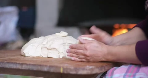Baker hands kneading dough in flour on the table Видео 163617815
