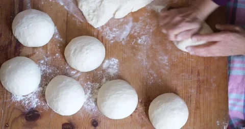 Baker hands kneading dough in flour on the table Видео 163618467