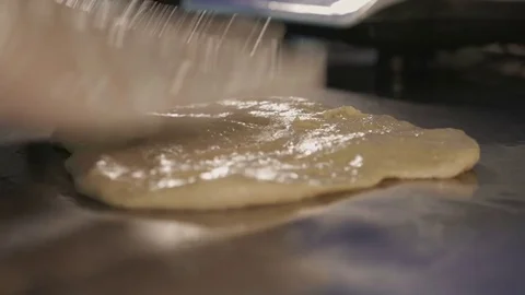 Baker hands kneading dough on table Stock Footage 84079049