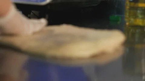 Baker hands kneading dough on table Stock Footage 84080876