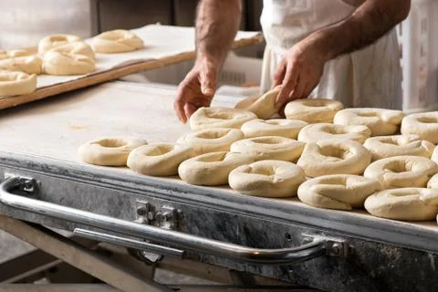 Baker hands making bread donuts Stock Photos