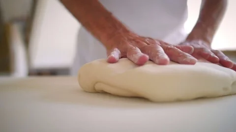 Baker hands preparing the dough with flour Stock-Footage 76558914