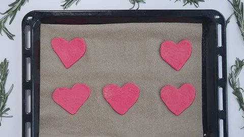 Baker hands put heart shaped pink cookie to oven tray and take it off. Valentine 스톡 동영상 121827050