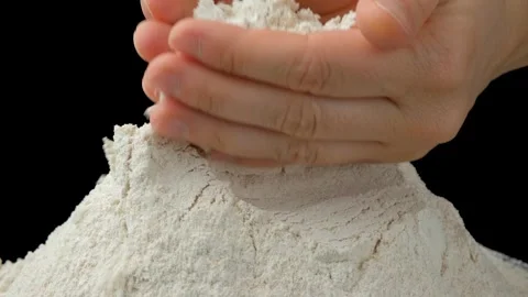 Baker hands scooping organic spelt flour from heap close up Stock Footage 346761091