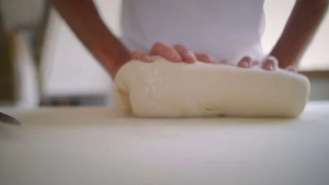 Baker hands stretching the dough Stock Footage 76559147