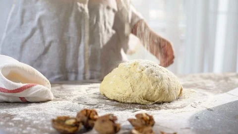 Baker hands throwing flour kneading dough in flour on table. Slow motion. 動画素材 96401522