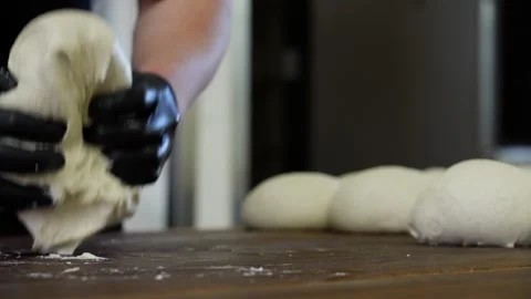 Baker hands working with dough close-up of kneading and shaping bread loaves Stock Footage 313532948