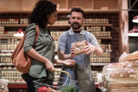Baker helping customer in grocery store Stock Photos