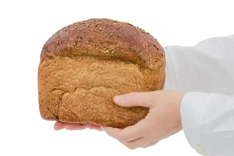 Baker holding fresh bread in the hands of, isolated on white background Photos