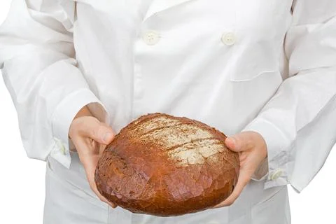 Baker holding fresh bread in the hands of, isolated on white background Photos