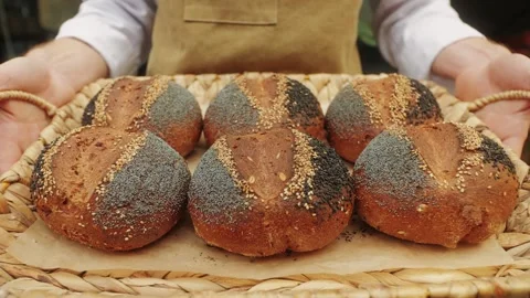 The baker holds in hands a of fresh bread close-up. Artisan bread is making by Stock Footage 270020162