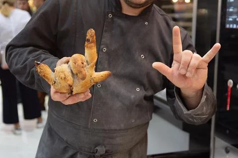 A baker holds his side in the shape of a hand Foto stock
