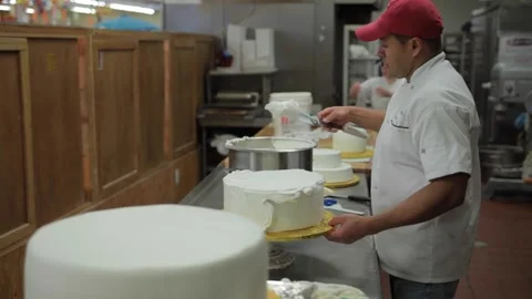 Baker icing a cake in a bakery. Stock Footage 231414513