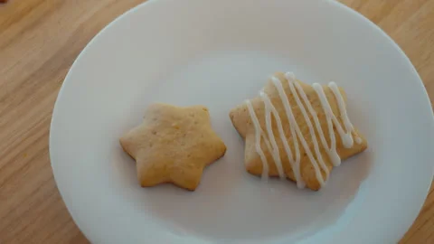 Baker is icing delicious baked cookies Stock Footage 276569941