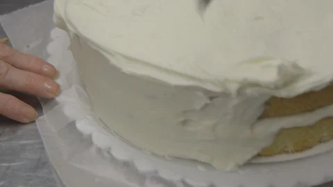 Baker icing a two layer cake Stock Footage 104866664