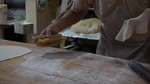 Baker kneading and cleaning Stockbeeldmateriaal 345375521