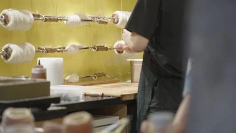 Baker kneading and preparing dough for a trdelnik, a traditional spit cake Vídeo Stock 334107061