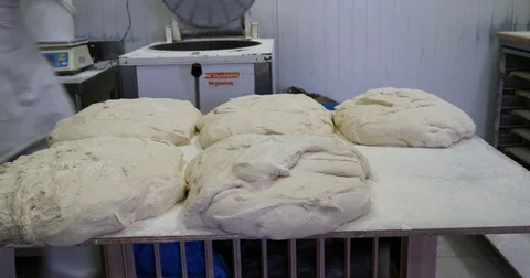Baker kneading dough and preparing buns and bread mix for the oven Stock Footage 83996627