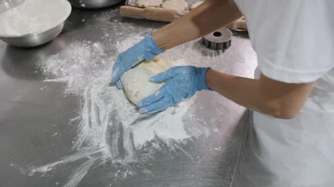 Baker Kneading Dough with Blue Gloves. Bakery production Stock Footage 321363078