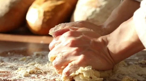 Baker kneading dough in flour on table Stock Footage 10735236