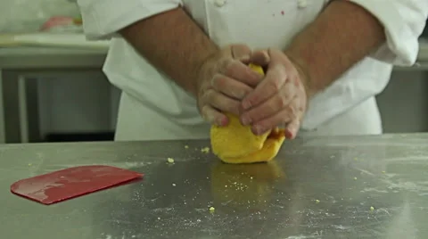 Baker kneading dough in flour on table, professional cooker in kitchen Stock Footage 48660048