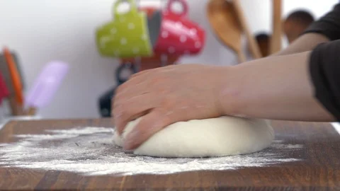 Baker kneading dough in flour on table Stock Footage 88628857