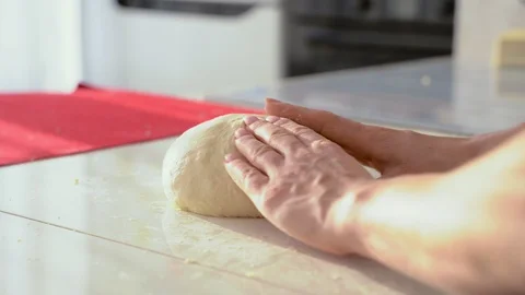 Baker kneading dough in flour on table. Close up of female hands working with Stock Footage 105090255