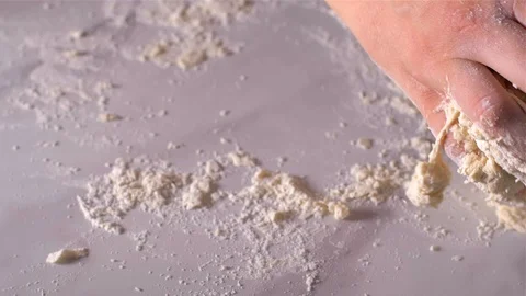 Baker kneading dough in flour on table, slow motion Stock Footage 106152289